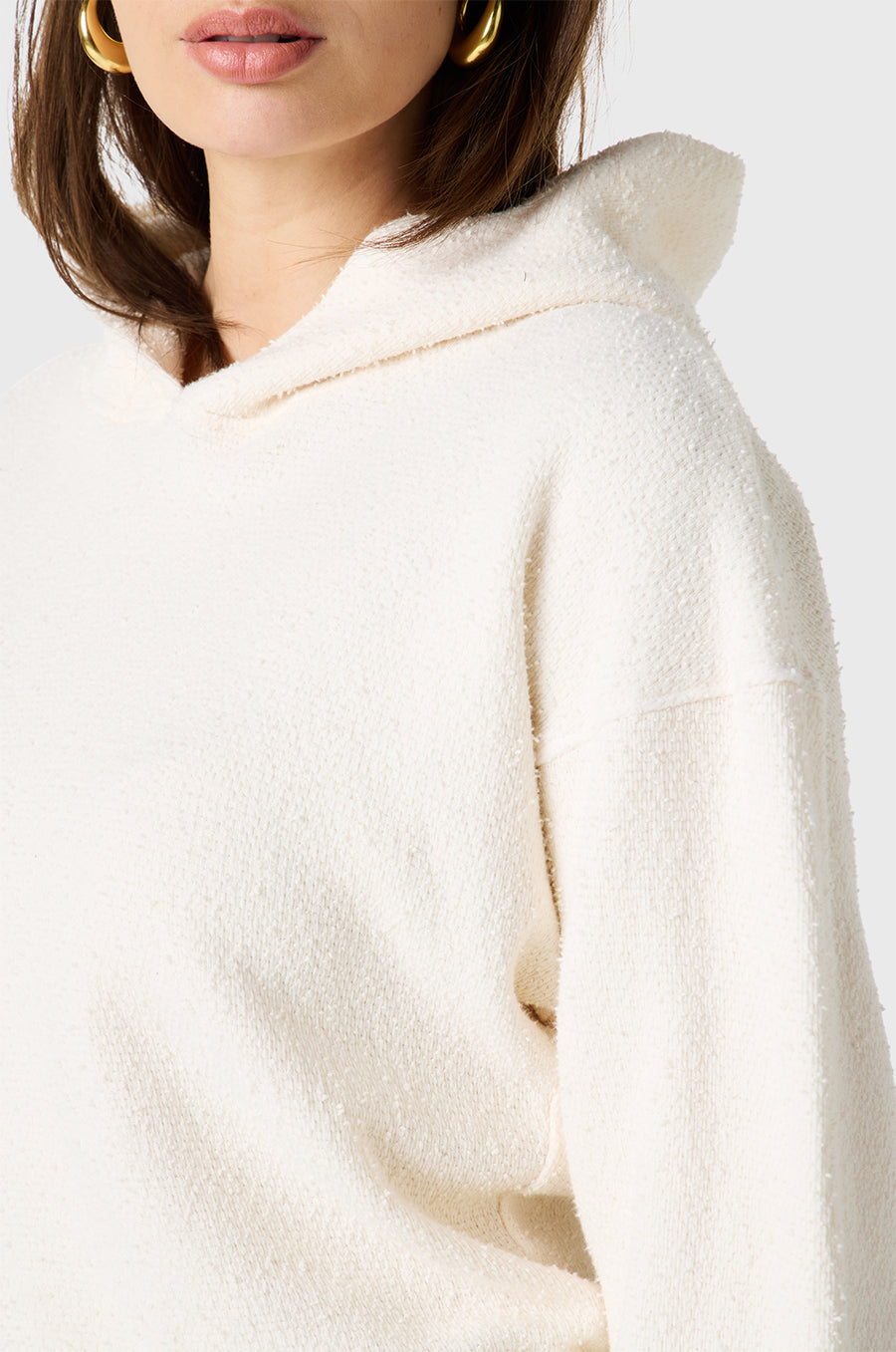 Brunette Model wearing the lady & the sailor Hoodie in Vanilla Bouclé
