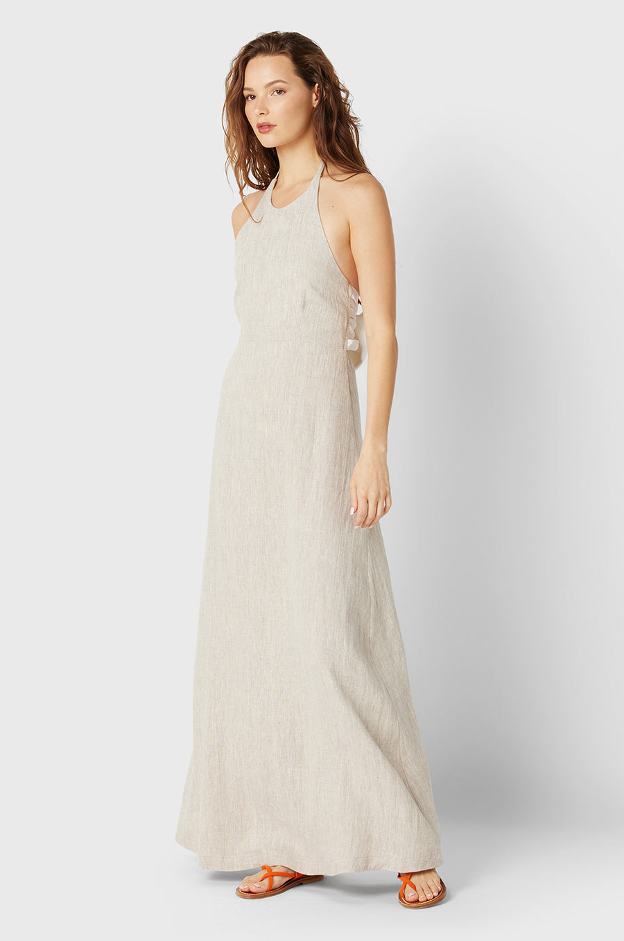 Brunette Model wearing the lady & the sailor Lilou Dress in Natural/White Linen.