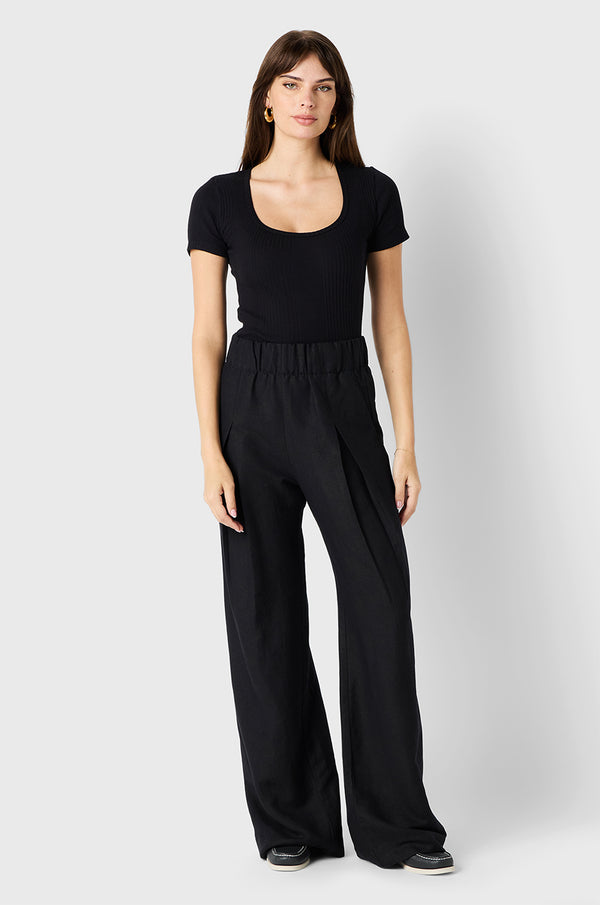 Brunette Model wearing the lady & the sailor Pleated Trouser in Black