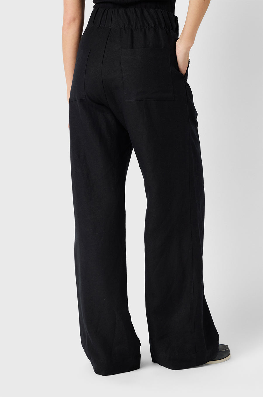 Brunette Model wearing the lady & the sailor Pleated Trouser in Black