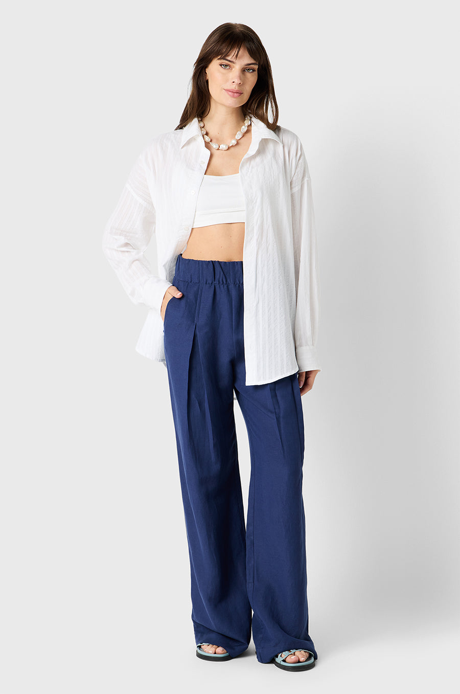 Brunette Model wearing the lady & the sailor Pleated Trouser in Nautical Navy