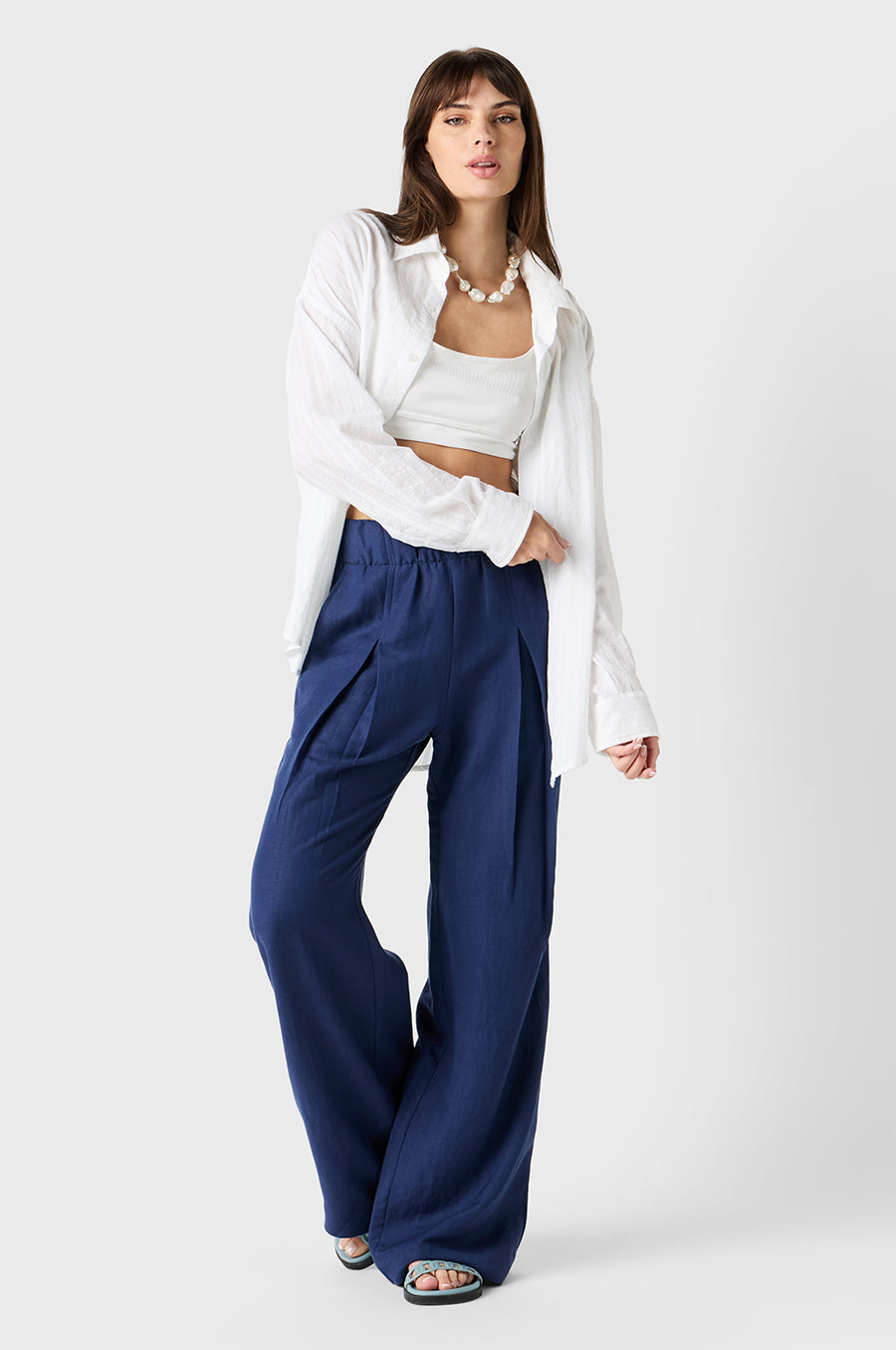 Brunette Model wearing the lady & the sailor Pleated Trouser in Nautical Navy