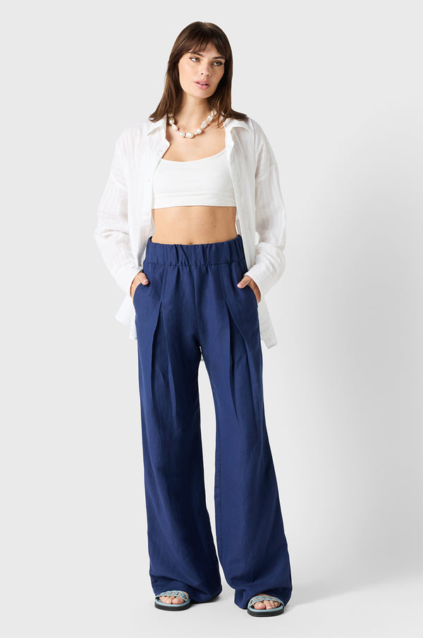 Brunette Model wearing the lady & the sailor Pleated Trouser in Nautical Navy
