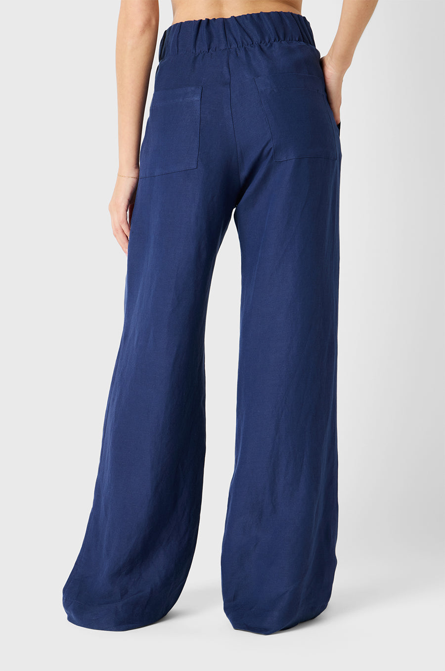Brunette Model wearing the lady & the sailor Pleated Trouser in Nautical Navy