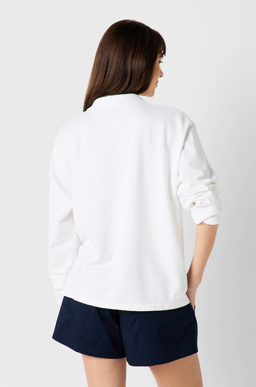 Brunette Model wearing the lady & the sailor BF Polo in White Twill Cotton
