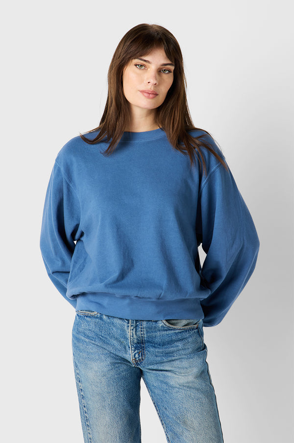 Brunette Model wearing the lady & the sailor Relaxed Sweatshirt in Sea Blue Organic Cotton