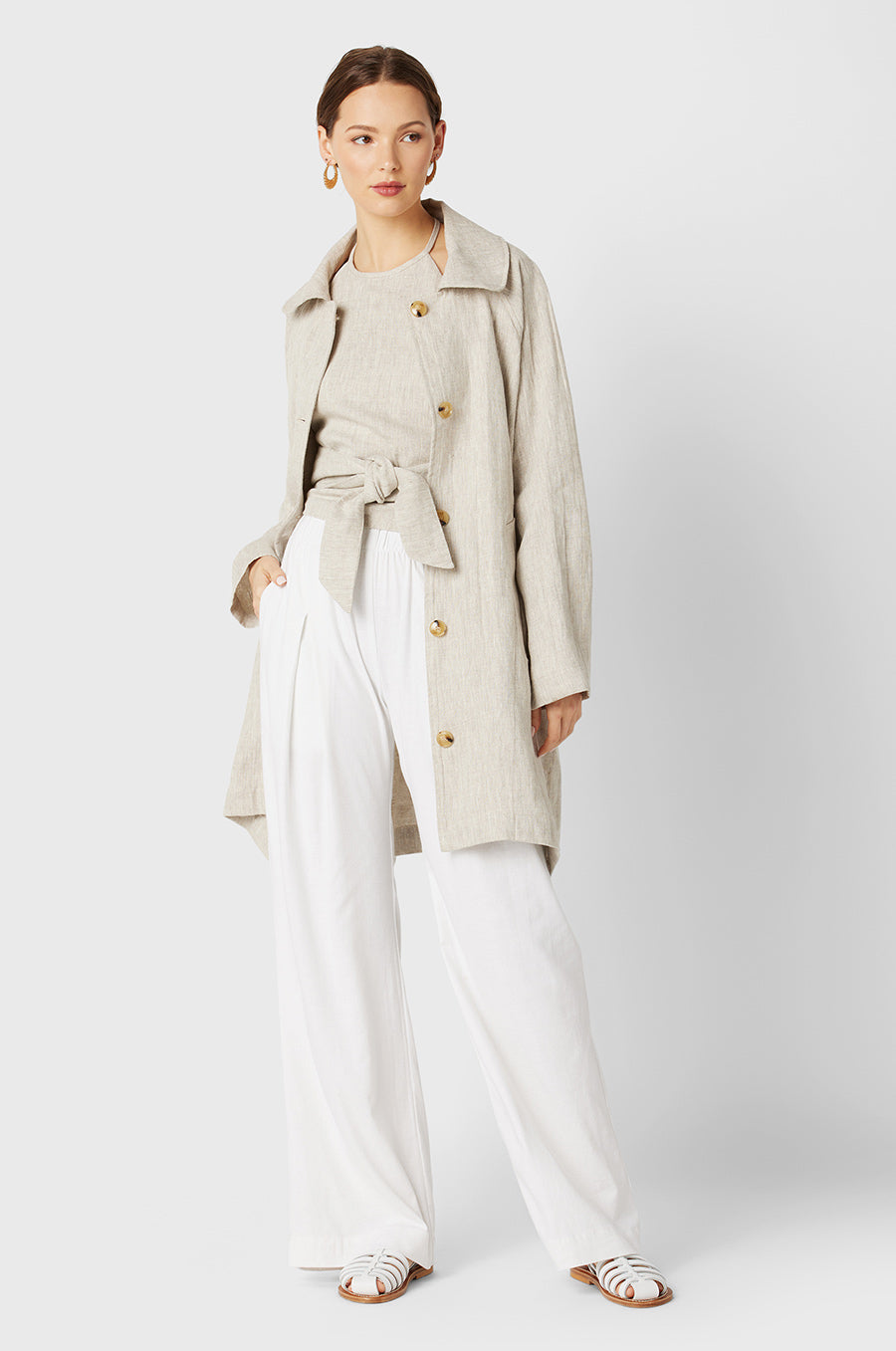 Brunette Model wearing the lady & the sailor Swing Coat in Natural Linen.