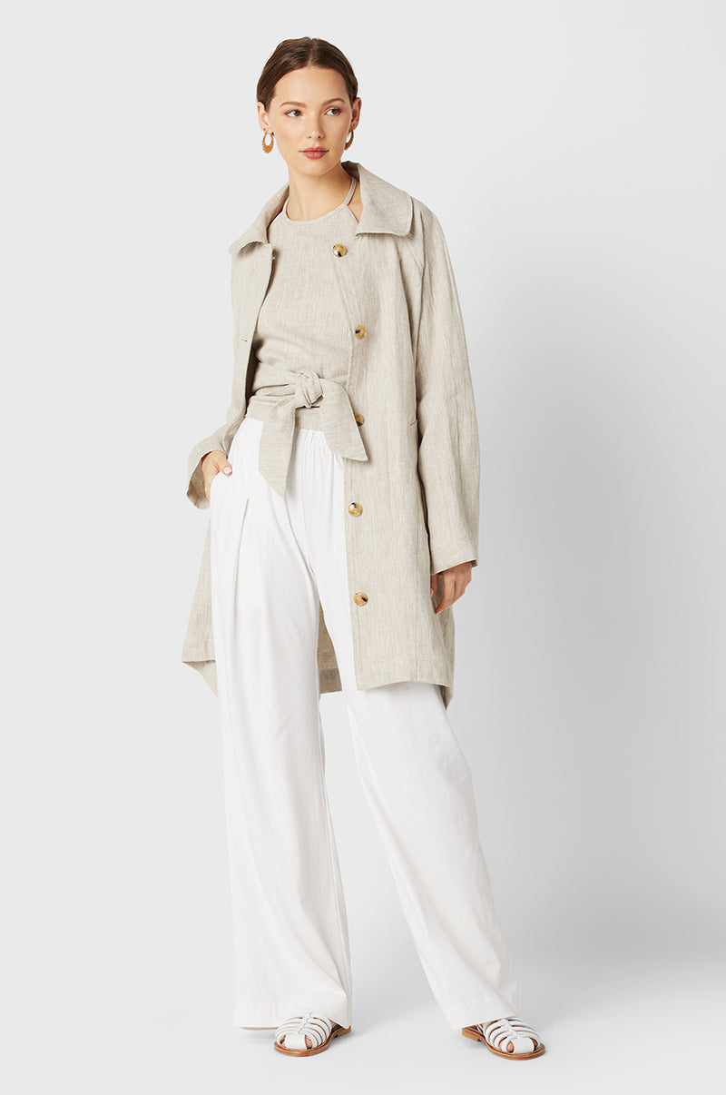 Brunette Model wearing the lady & the sailor Swing Coat in Natural Linen.