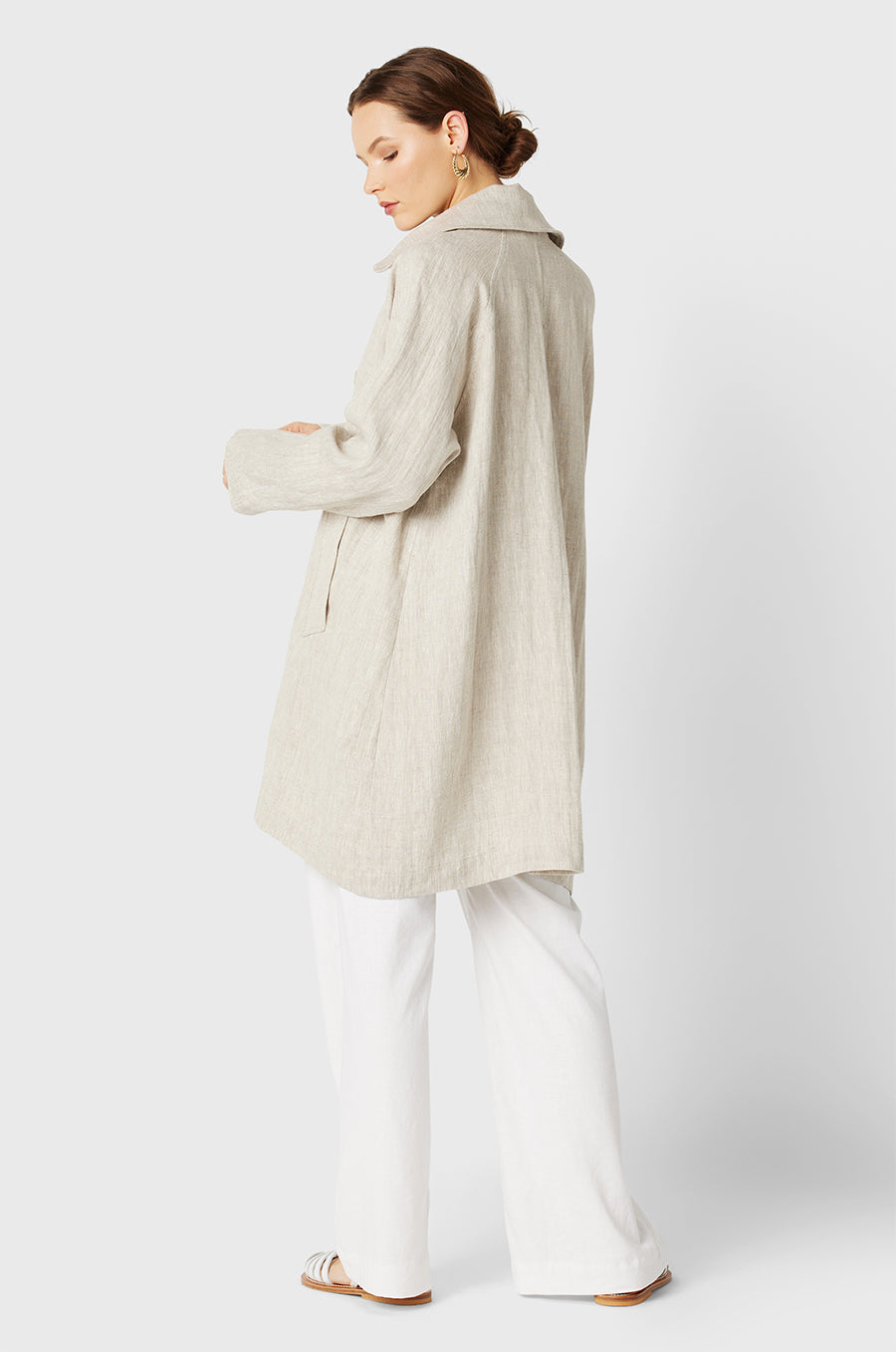 Brunette Model wearing the lady & the sailor Swing Coat in Natural Linen.