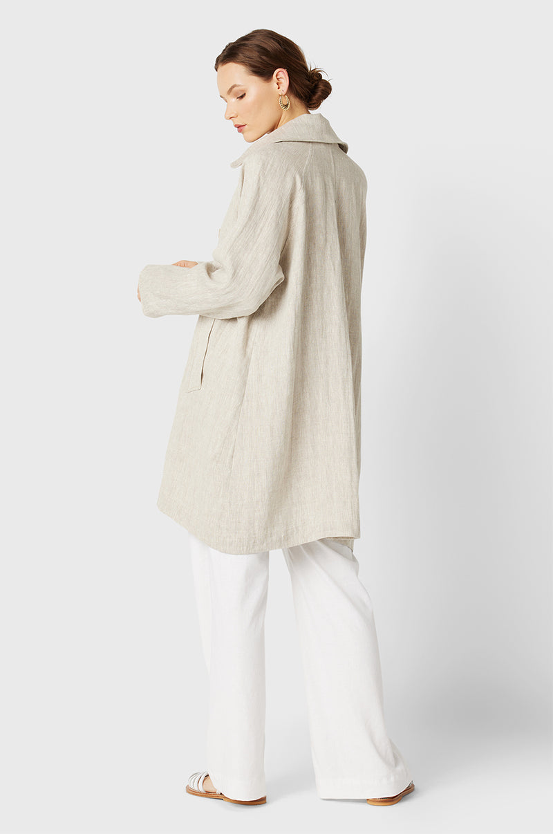 Brunette Model wearing the lady & the sailor Swing Coat in Natural Linen.