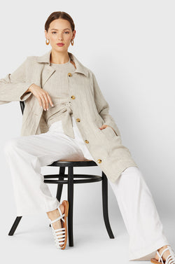 Brunette Model wearing the lady & the sailor Swing Coat in Natural Linen.