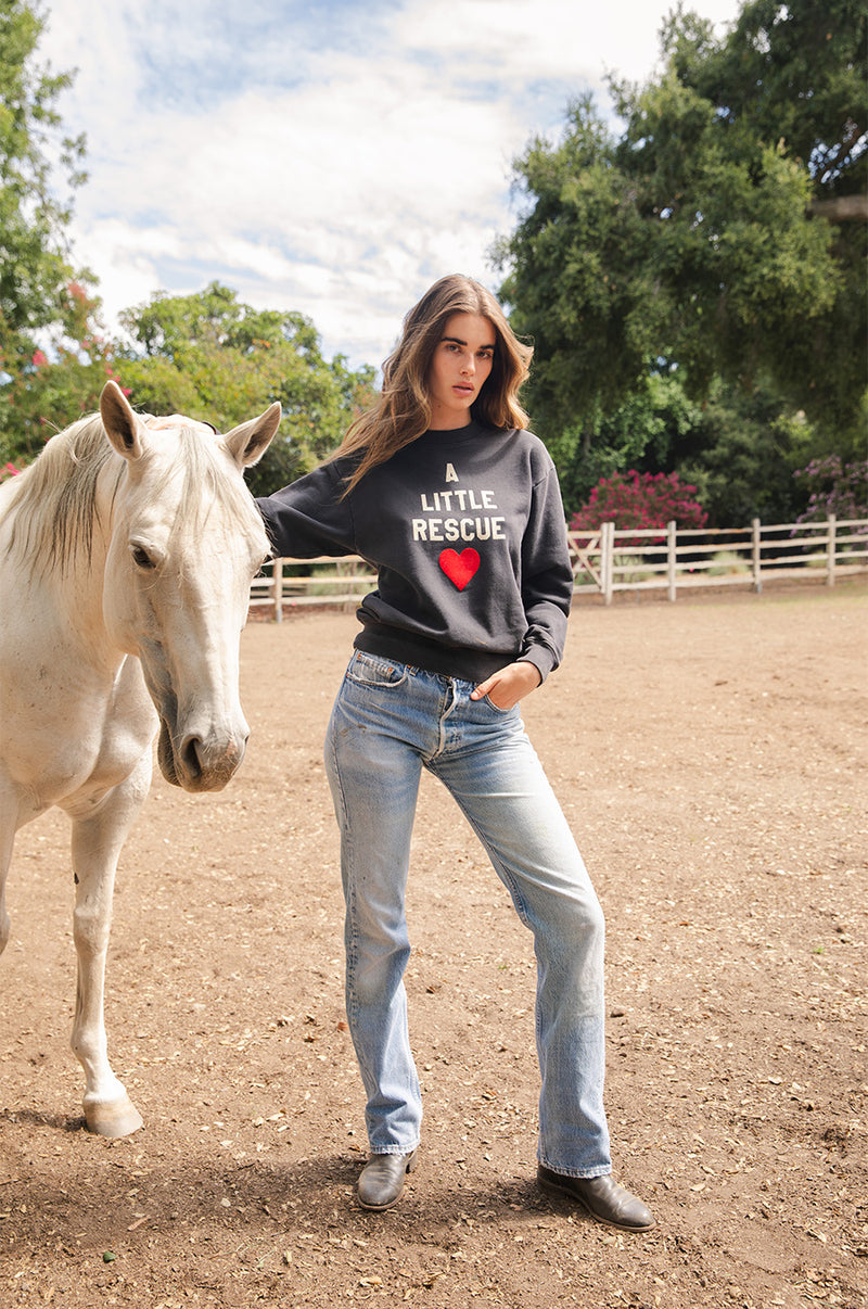 Brunette model wearing the lady & the sailor A little Rescue Sweatshirt in Vintage Black.
