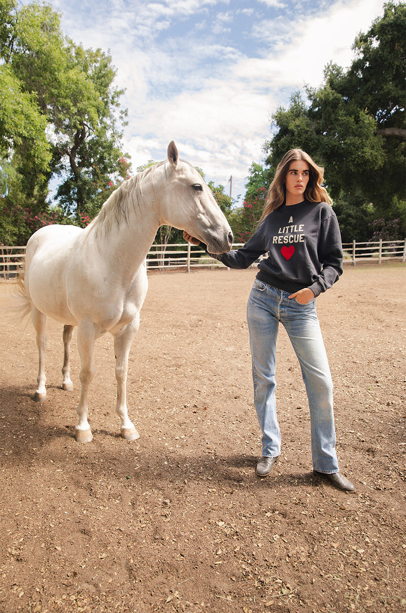Brunette model wearing the lady & the sailor A little Rescue Sweatshirt in Vintage Black.
