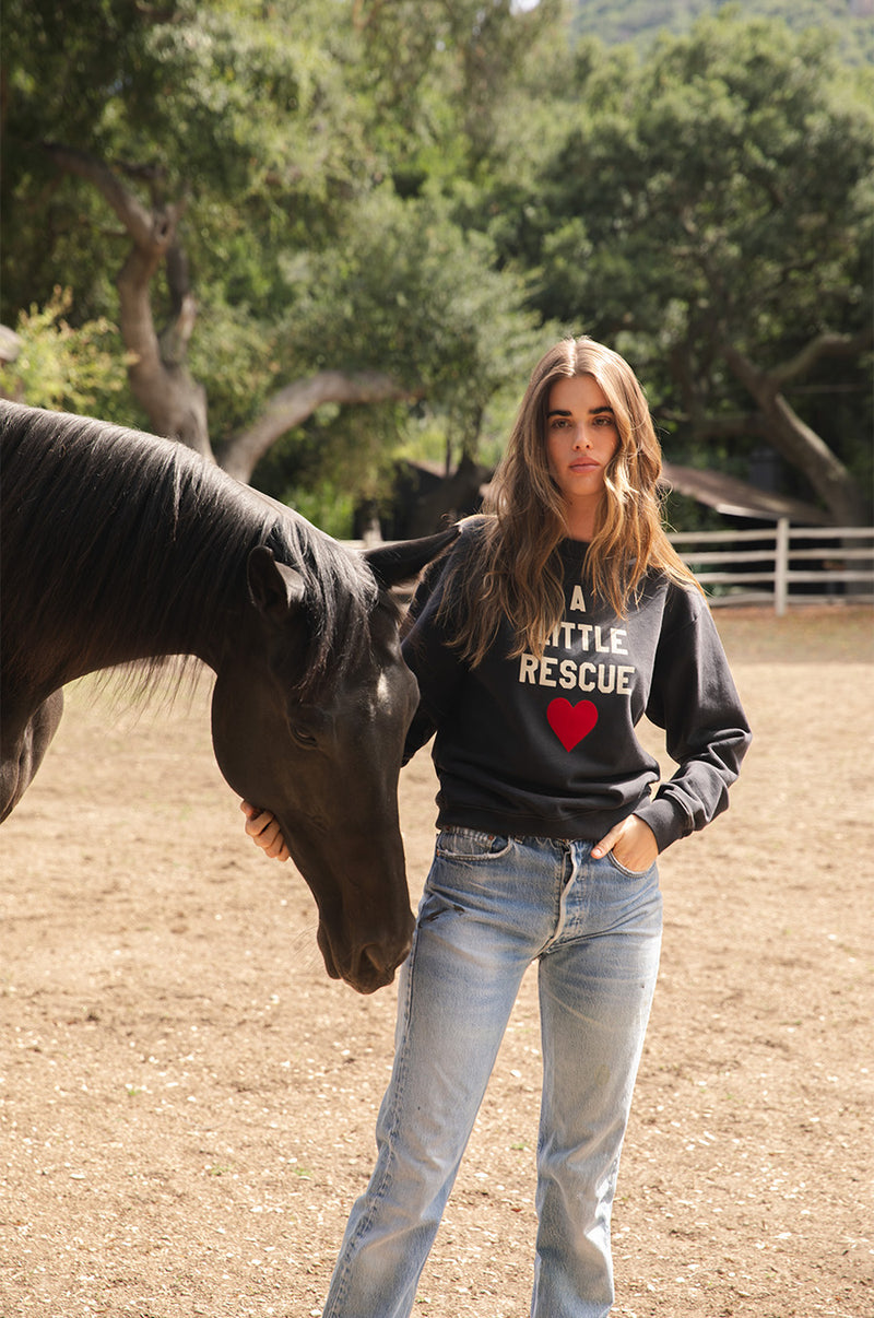 Brunette model wearing the lady & the sailor A little Rescue Sweatshirt in Vintage Black.