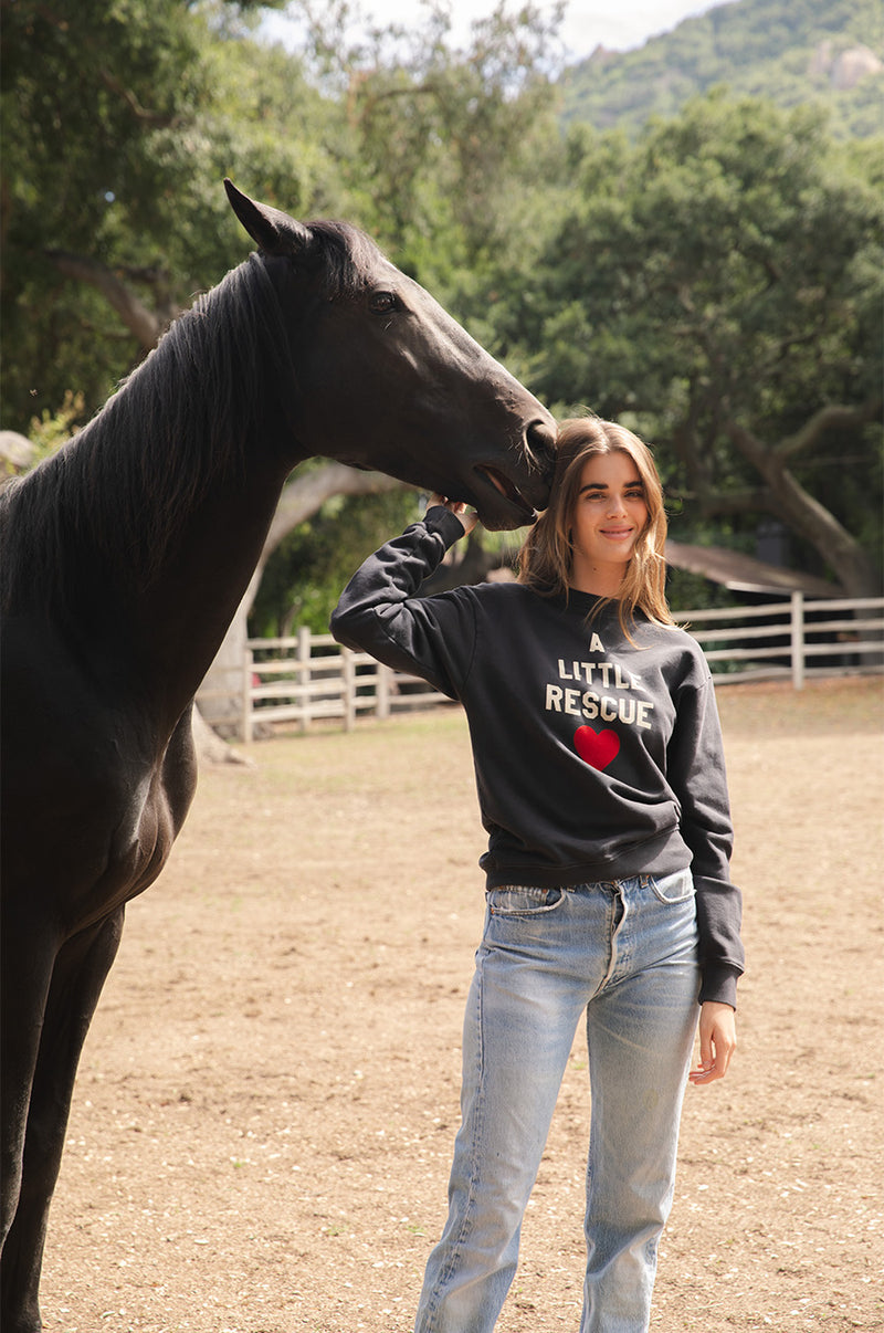 Brunette model wearing the lady & the sailor A little Rescue Sweatshirt in Vintage Black.