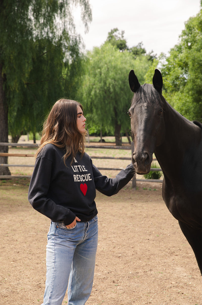 Brunette model wearing the lady & the sailor A little Rescue Sweatshirt in Vintage Black.