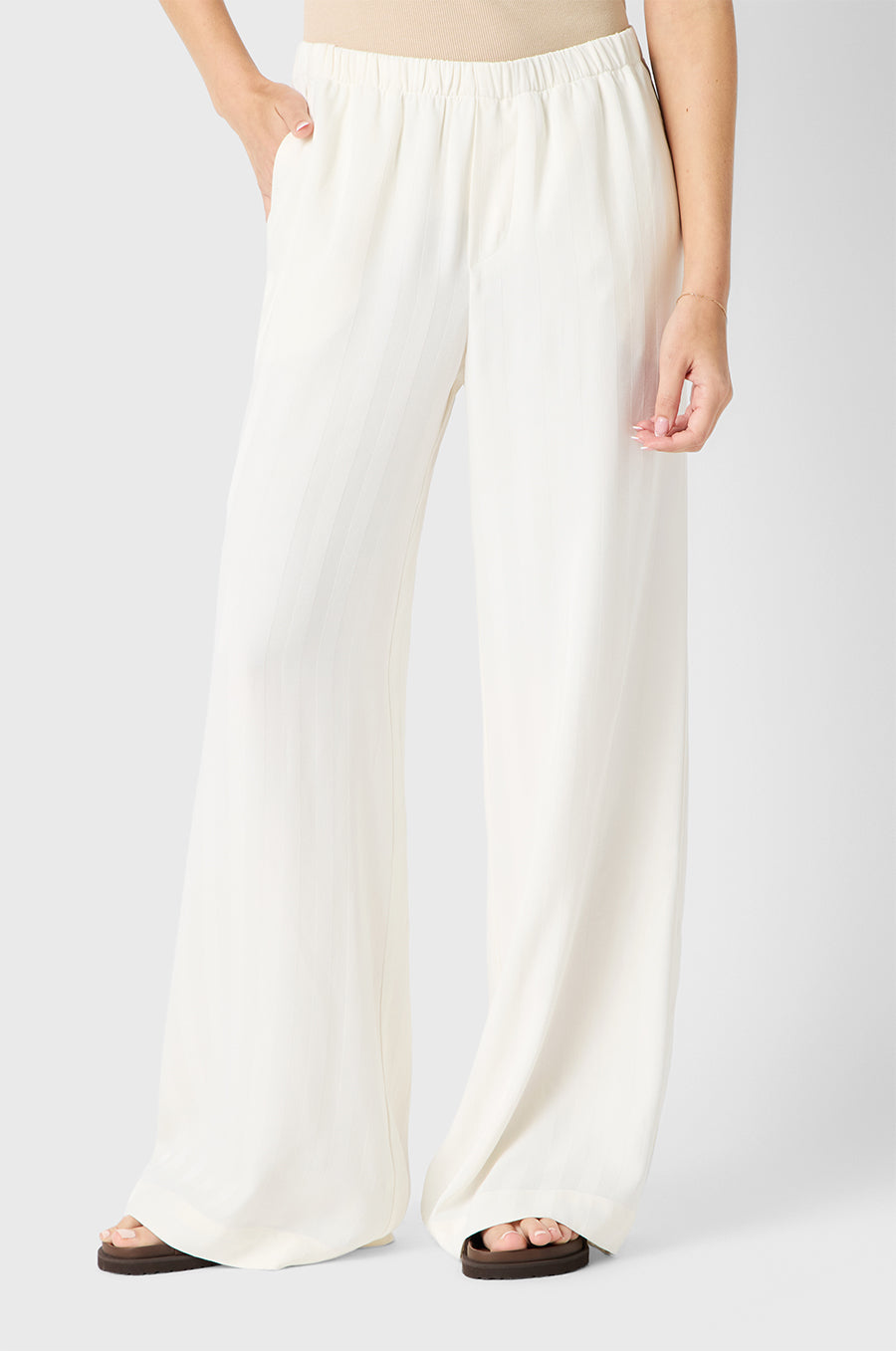 Brunette model wearing the lady & the sailor Wide Leg Pant in Ivory Sateen Stripe