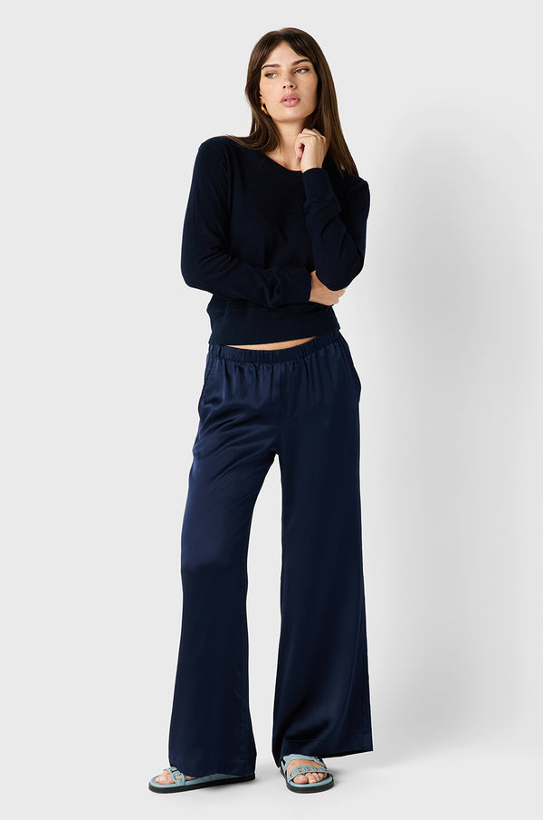 Brunette model wearing the lady & the sailor Wide Leg Pant in Navy Silk