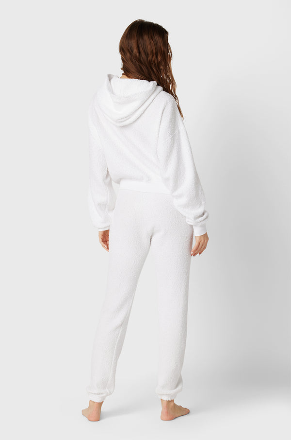 Brunette model wearing the lady & the sailor white boucle sweatpants. 