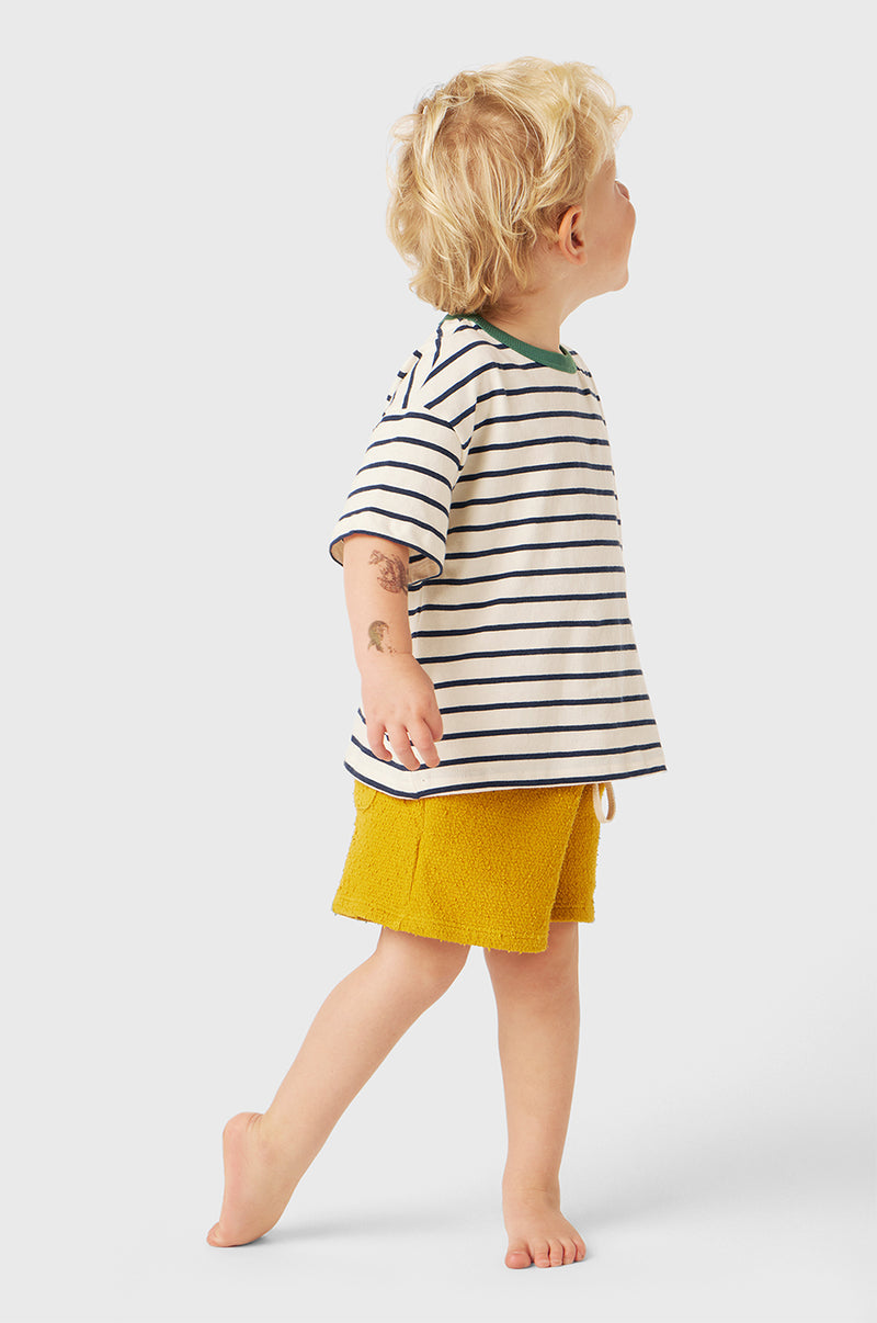 Model wearing Kids Weekend Short in Marigold Bouclé little lady & petit sailor