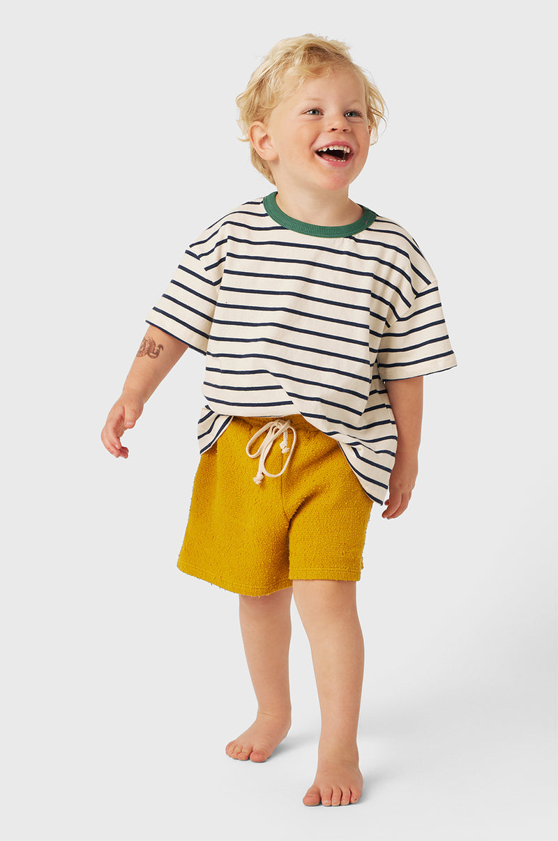 Model wearing Kids Weekend Short in Marigold Bouclé little lady & petit sailor