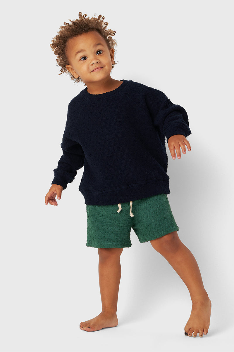 Model wearing Kids Weekend Short in Pine Bouclé little lady & petit sailor