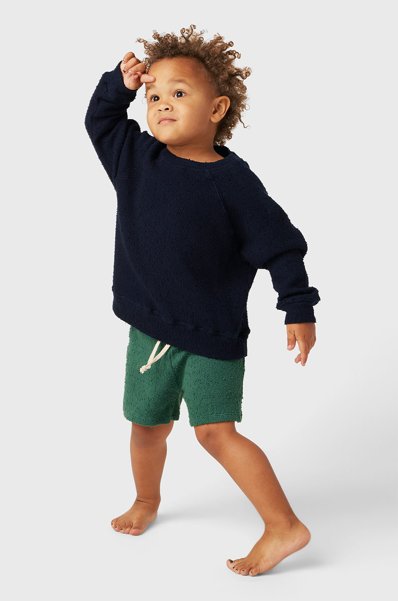 Model wearing Kids Weekend Short in Pine Bouclé little lady & petit sailor