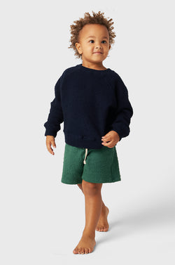 Model wearing Kids Weekend Short in Pine Bouclé little lady & petit sailor