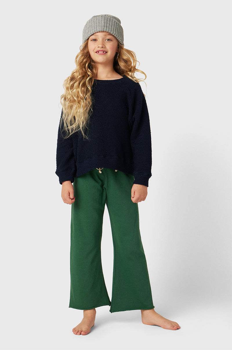 Model wearing Kids French Flare Pant in Pine Organic Cotton little lady & petit sailor