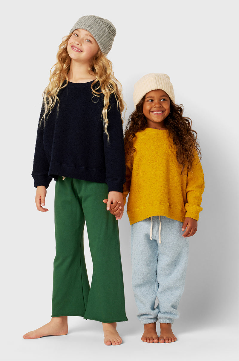 Model wearing Kids French Flare Pant in Pine Organic Cotton little lady & petit sailor