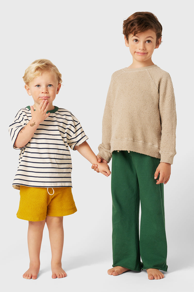 Model wearing Kids French Flare Pant in Pine Organic Cotton little lady & petit sailor