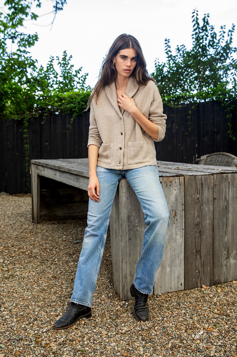 Brunette model wearing the lady and the sailor Pocket Cardi in Stone Bouclé.