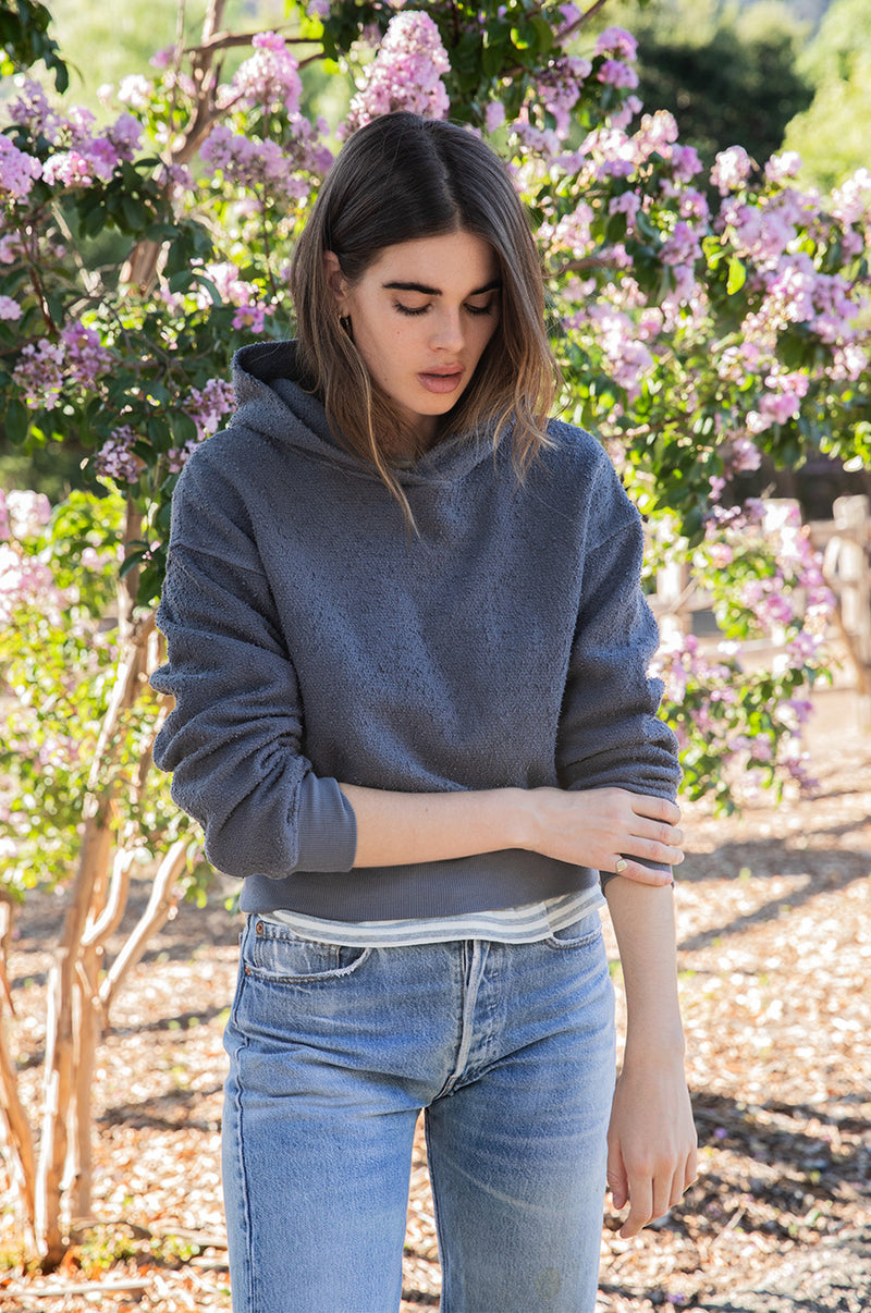 Brunette model the lady & the sailor Long Sleeve Boy Tee in Grey/Natural Stripe.