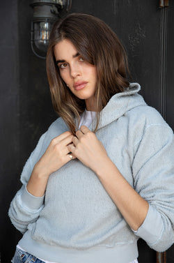 Brunette model wearing the lady and the sailor Hoodie in Seafoam Boucle.