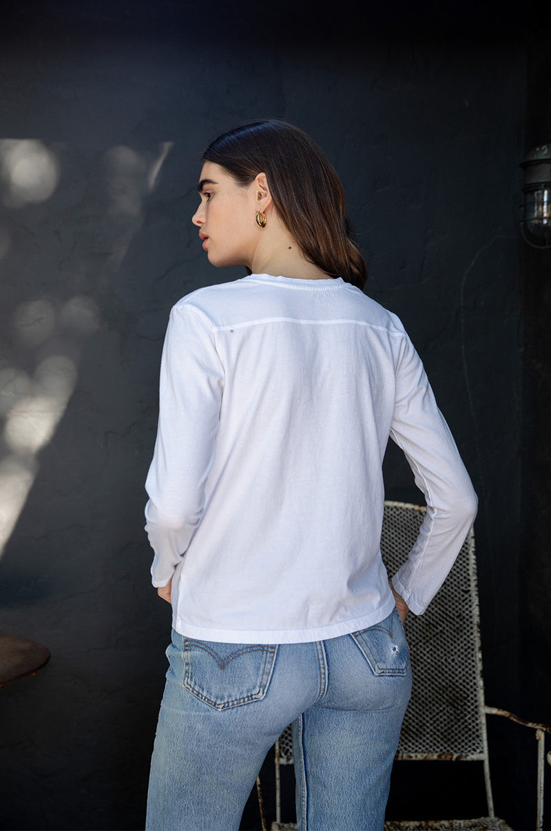 Brunette model wearing the lady & the sailor Long Sleeve Boy Tee in White.