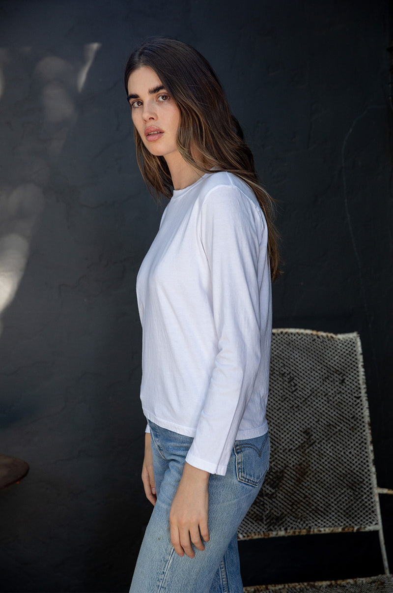Brunette model wearing the lady & the sailor Long Sleeve Boy Tee in White.