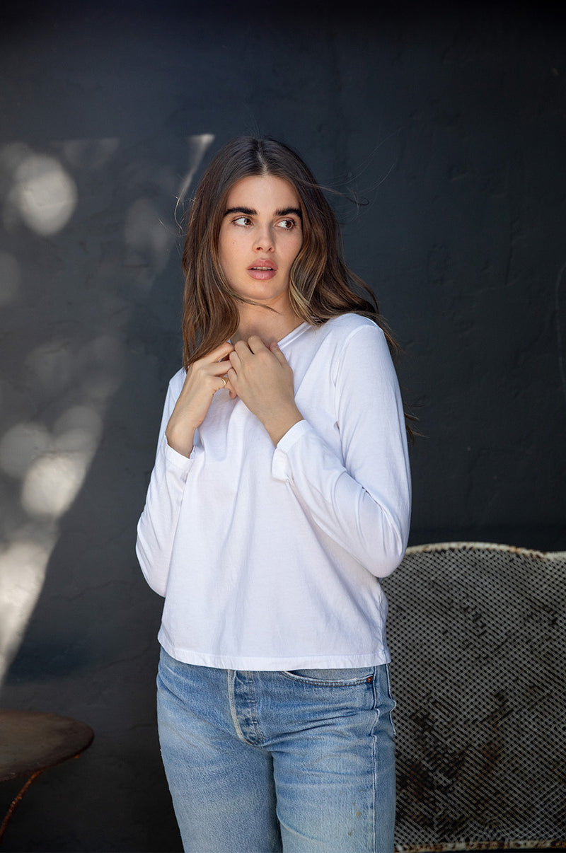 Brunette model wearing the lady & the sailor Long Sleeve Boy Tee in White.