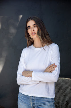 Brunette model wearing the lady & the sailor Long Sleeve Boy Tee in White.