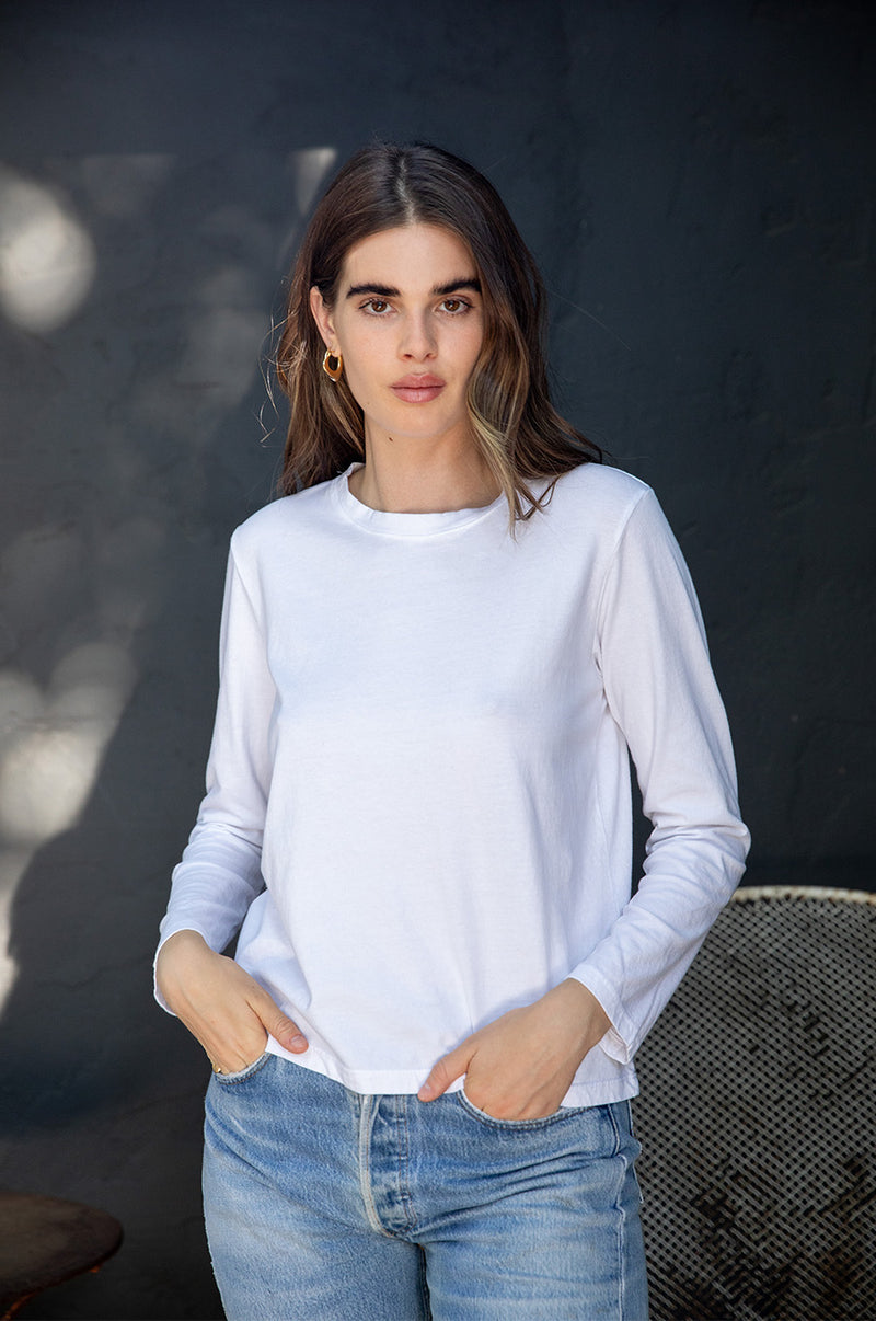 Brunette model wearing the lady & the sailor Long Sleeve Boy Tee in White.