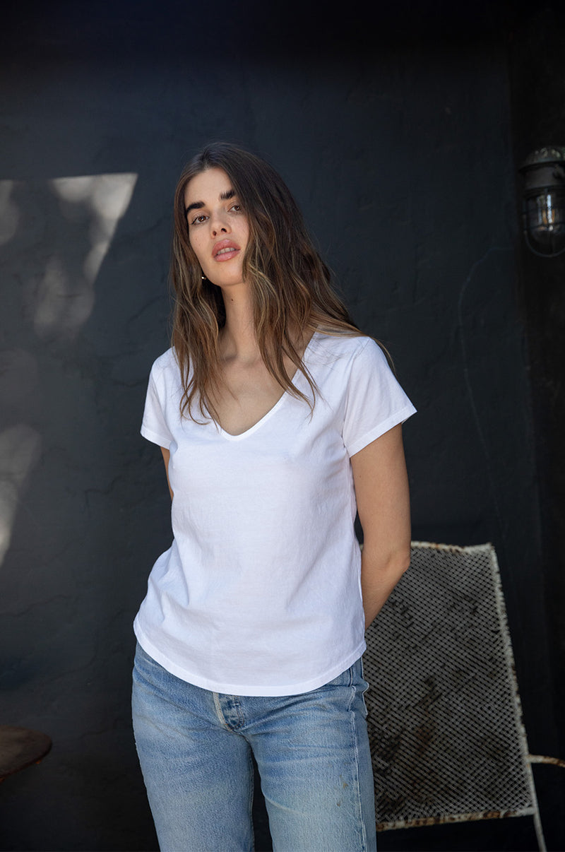 Brunette model wearing the lady & the sailor V Neck Tee in White Organic Cotton Jersey.