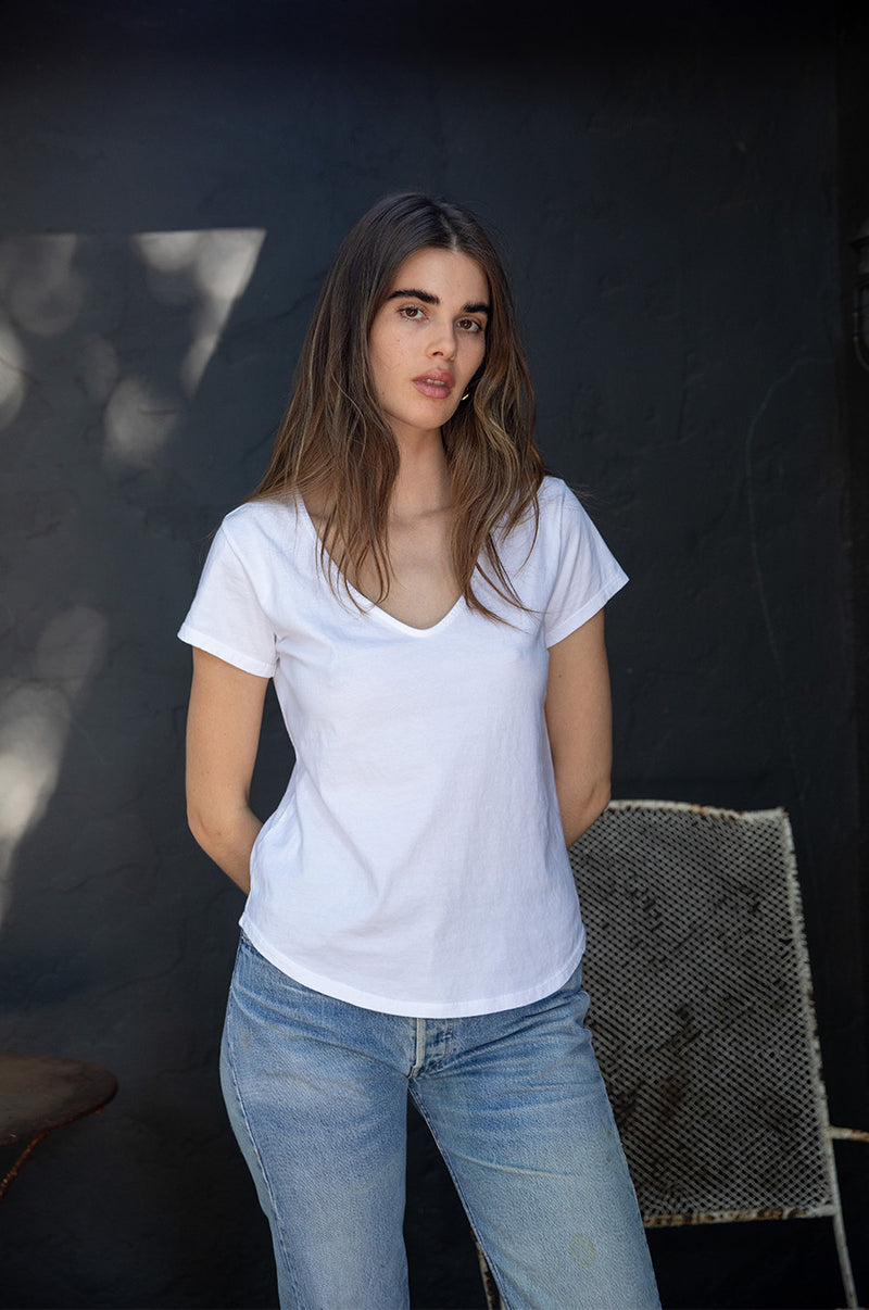 Brunette model wearing the lady & the sailor V Neck Tee in White Organic Cotton Jersey.