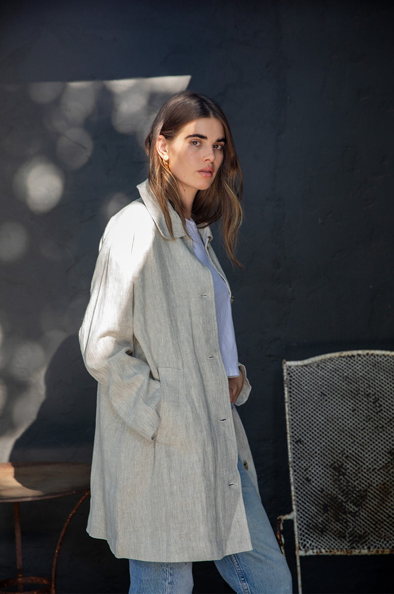 Brunette Model wearing the lady & the sailor Swing Coat in Natural Linen.