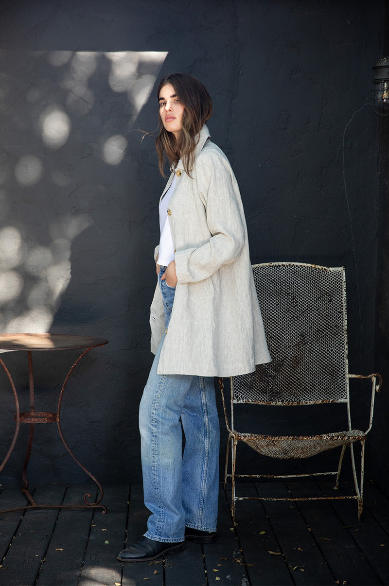 Brunette Model wearing the lady & the sailor Swing Coat in Natural Linen.