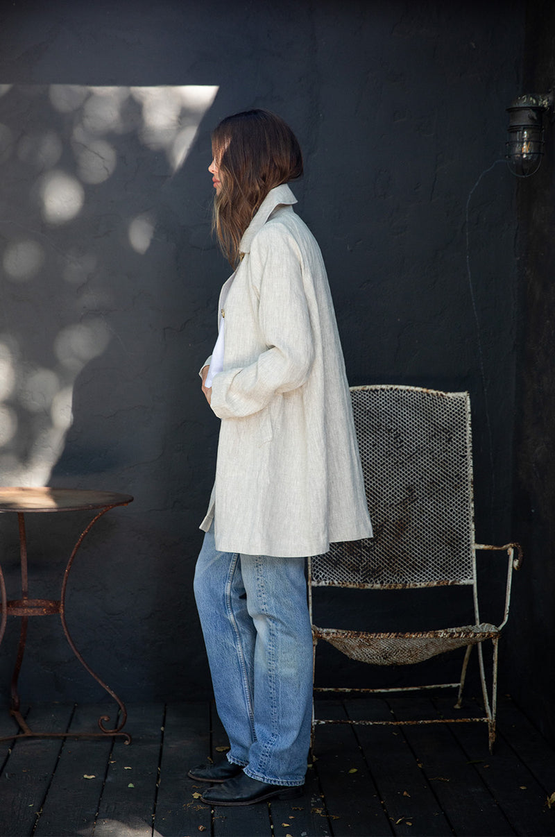 Brunette Model wearing the lady & the sailor Swing Coat in Natural Linen.