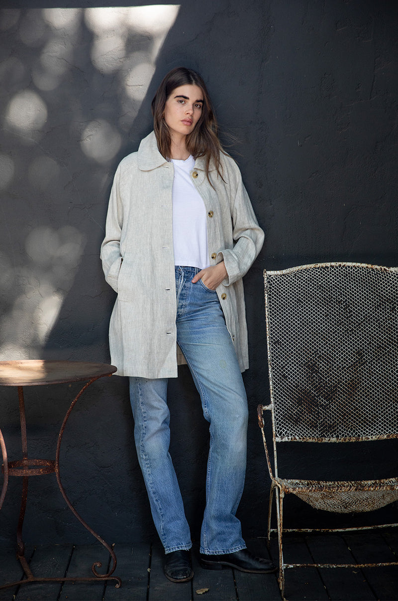 Brunette Model wearing the lady & the sailor Swing Coat in Natural Linen.