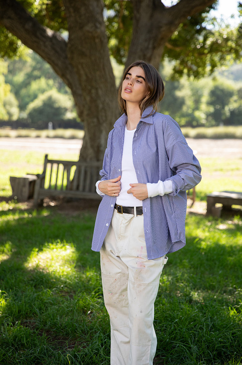 Brunette model wearing the lady & the sailor The Sunday Shirt in Navy Pinstripe.