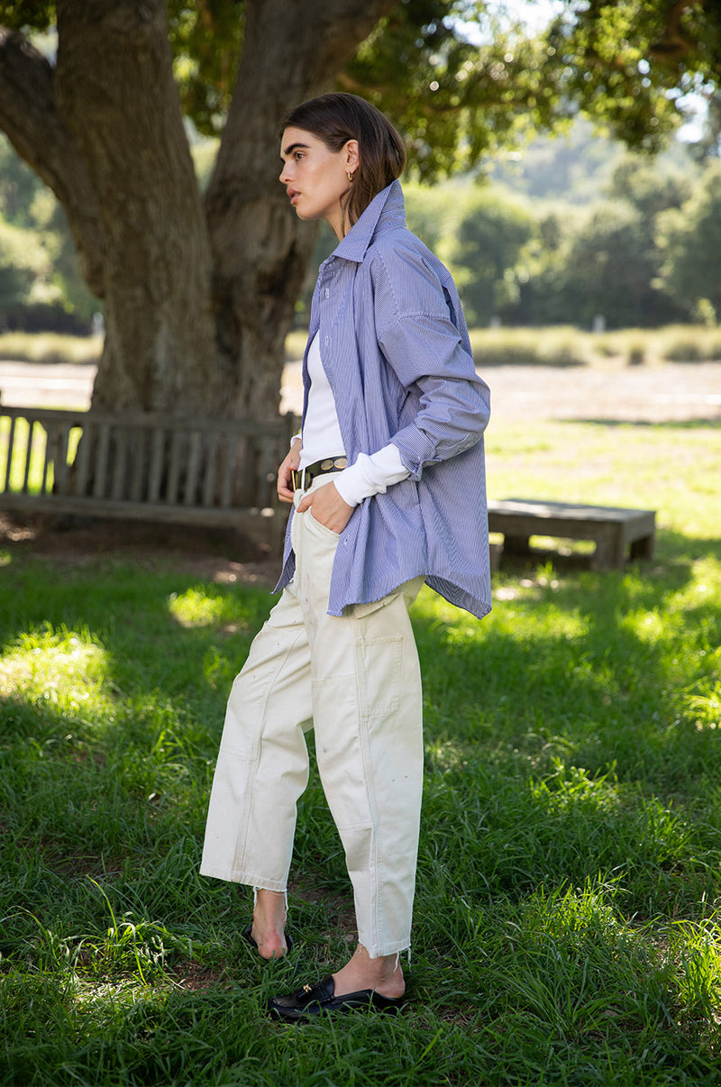 Brunette model wearing the lady & the sailor The Sunday Shirt in Navy Pinstripe.