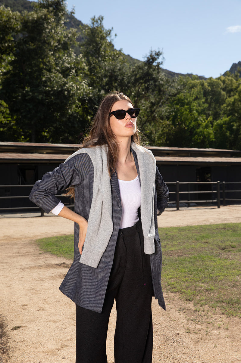 Brunette model wearing the lady & the sailor the Relaxed Blazer in Dark Denim Stripe.