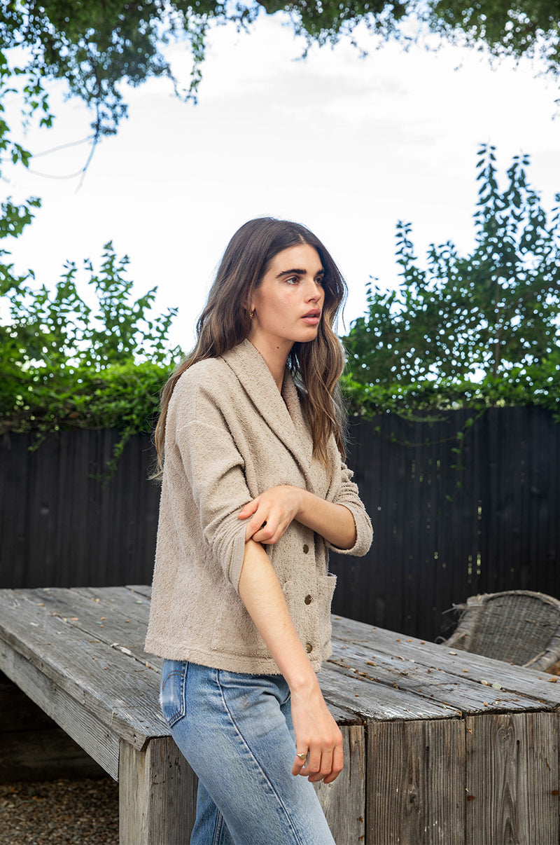 Brunette model wearing the lady and the sailor Pocket Cardi in Stone Bouclé.