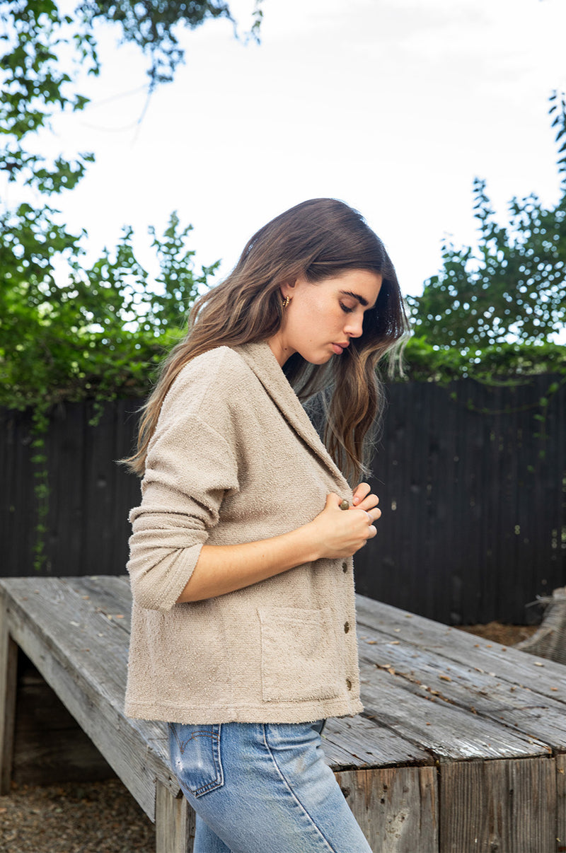 Brunette model wearing the lady and the sailor Pocket Cardi in Stone Bouclé.